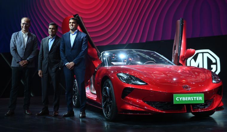 Rajeev Chaba, CEO Emeritus of MG Motor India; Sajjan Jindal, Managing director of JSW Steel and Parth Jindal, Managing Director, JSW Cement and Paints pose with MG Cyberset during a Mumbai event